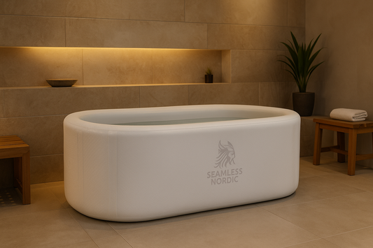 White freestanding bathtub with 'Seamless Nordic' logo in a bathroom setting.